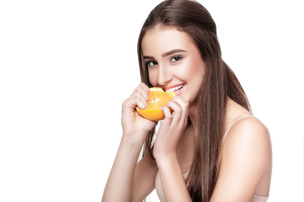 woman with orange on white background - Foto, Bild