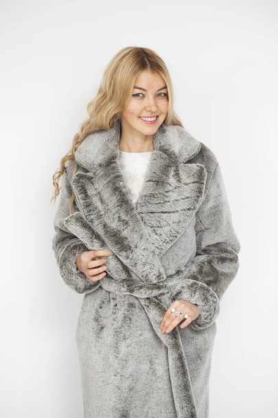 Young beautiful blonde woman in gray fur coat  - Foto, Imagen