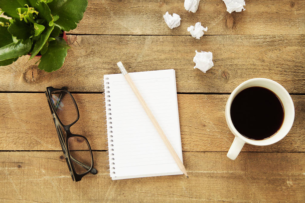 Notebook with drinking coffee on wooden table - Φωτογραφία, εικόνα