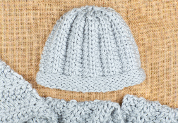 Woolen scarf and cap isolated on linen background. - Foto, Bild