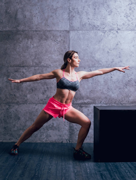 Young athletic caucasian woman posing in studio and doing different exercises. - 写真・画像