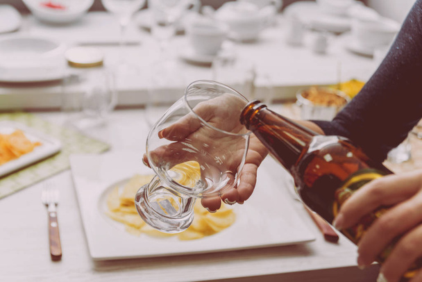 Glass of lager beer in the hands. Restaurant - Foto, Imagem