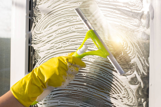 Cleaner scraper cleans the glass window. - Fotoğraf, Görsel