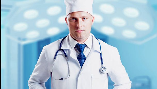 Adult caucasian blue eyed doctor posing on hospital background - Foto, imagen