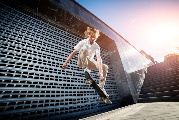 Skateboarder practicing and jumping on the streets - Fotografie, Obrázek