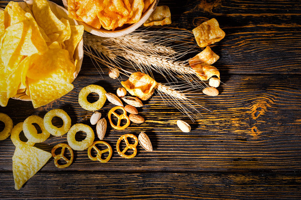 Top view of two plates with chips near wheat, scattered nuts and - Foto, Imagem