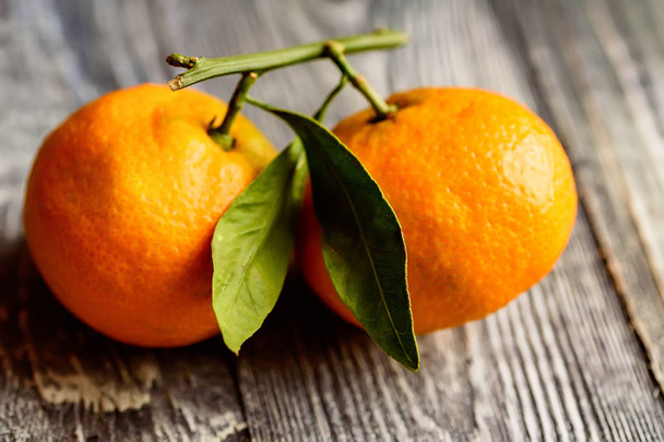 Mandarine orange or tangerine on wooden board - 写真・画像