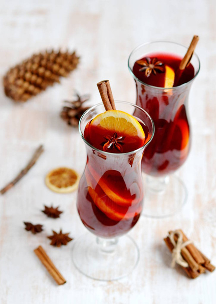 Two Glass of Hot Red Wine Wooden Background Cone Cinnamon Orange Winter Decor  - Photo, Image