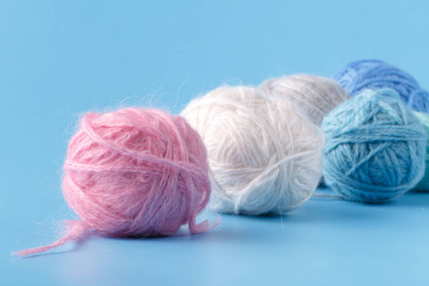 Needlework hobby concept. Wool clews on blue background - Foto, Imagem