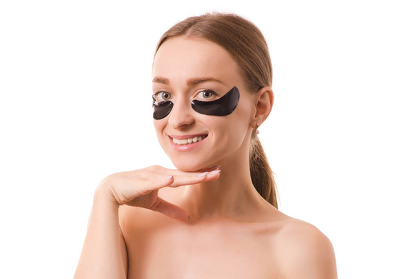 Beautiful young woman face patches under eyes - Foto, Bild