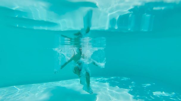Подводный вид человека в бассейне
 - Фото, изображение