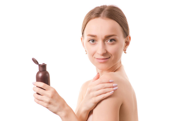 Beautiful young woman beauty bottle face with cosmetics for body and face oil lotion - 写真・画像