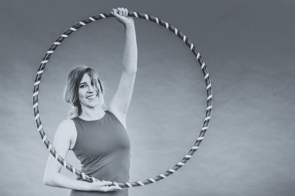 Fit woman with hula hoop doing exercise - Valokuva, kuva