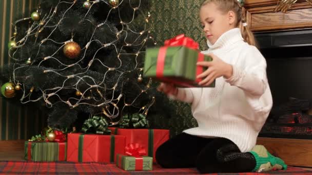 Girl choosing the best Christmas present for herself. - Footage, Video