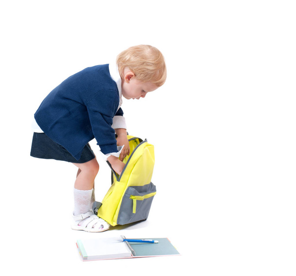 Happy little schoolgirl. Child with backpack and books. - Fotoğraf, Görsel