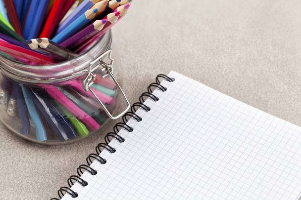 Notebook and colored pencils in a jar - Fotografie, Obrázek