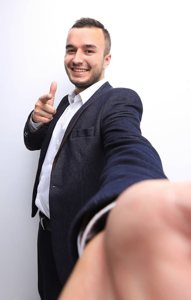 Happy successful businessman pointing on copy space - Foto, Imagen
