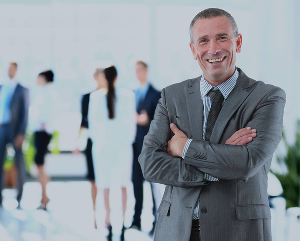 Happy mature business man looking at camera with satisfaction at office - Photo, Image