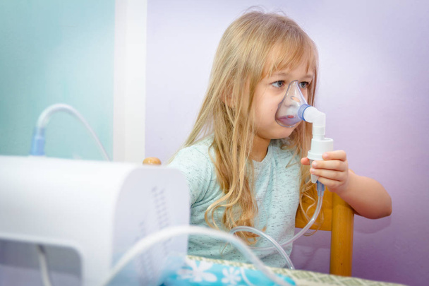 Portrait of sweet little girl using an inhaler  - Zdjęcie, obraz