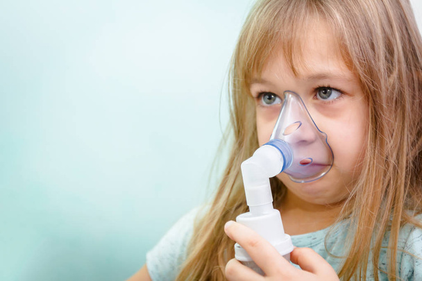 Portrait of sweet little girl using an inhaler  - Photo, Image