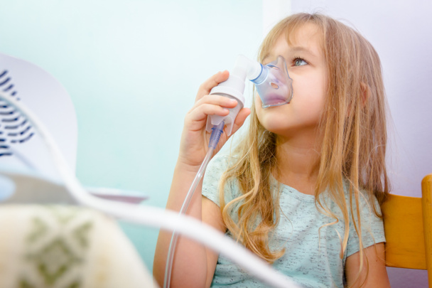 Portrait of sweet little girl using an inhaler  - Foto, imagen