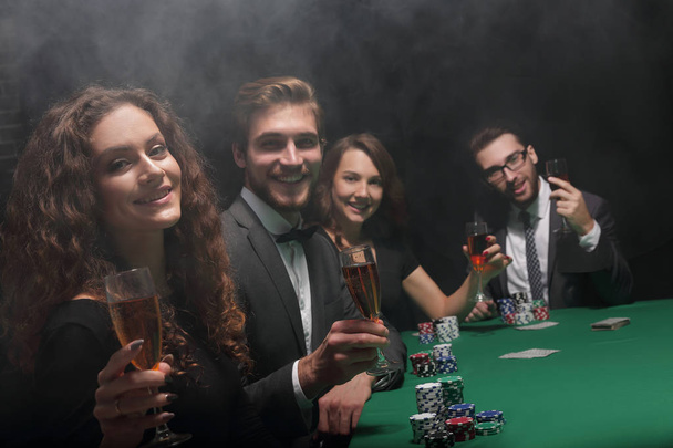 poker players sitting at a table in a casino - Foto, Imagen