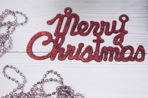 Merry christmas red gleaming inscription on a whitewooden background - Photo, Image