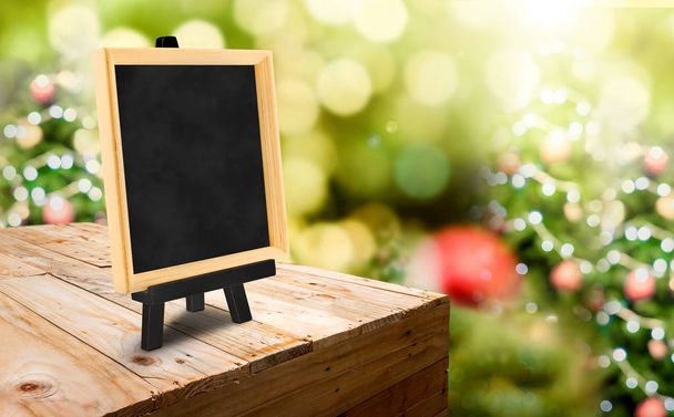 Blackboard with easel on wood table ( food stand ) at blur Chris - Fotó, kép