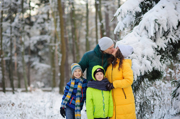 Family portrait in the winter forest. - Photo, Image