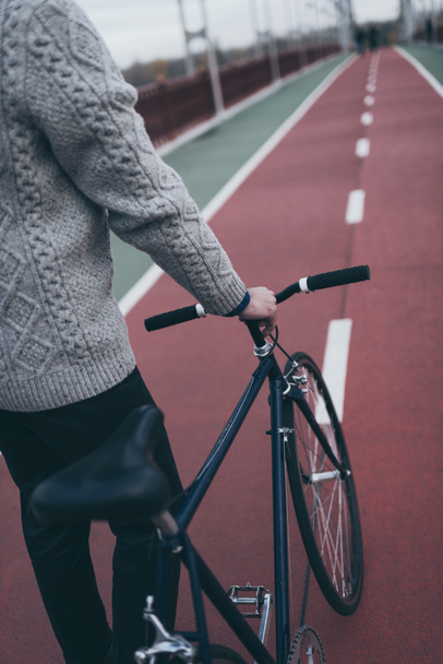 cropped shot of man with vintage bicycle on pedestrian bridge - Fotó, kép