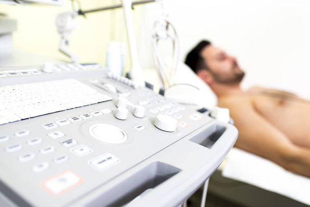 Young male patient in the ultrasound examination - Photo, Image