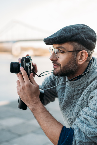 hombre adulto con estilo con cámara de película vintage al aire libre
 - Foto, Imagen