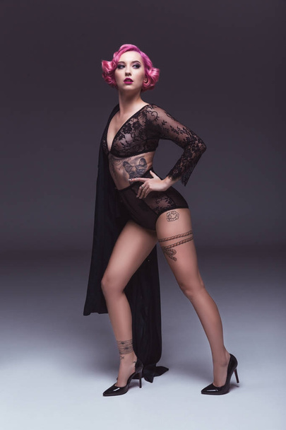 seductive tattoed pin up girl in transparent lingerie infront of grey background - Fotografie, Obrázek
