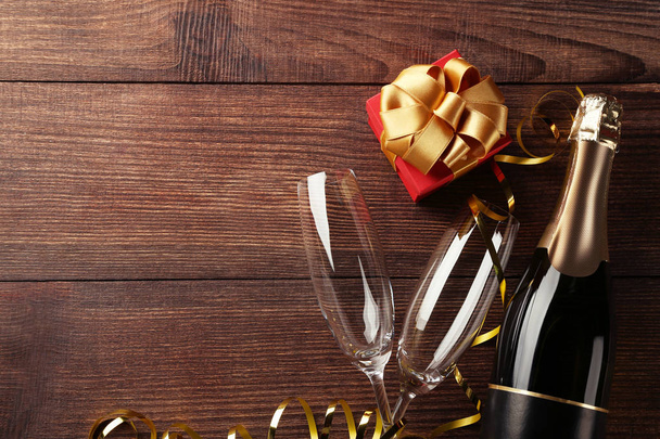Bouteille de champagne avec verres et coffret cadeau sur table en bois marron
 - Photo, image