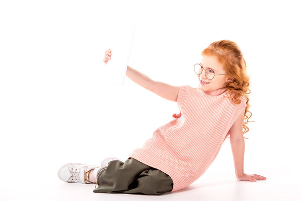 kid with ginger hair taking selfie with tablet on white - Photo, Image