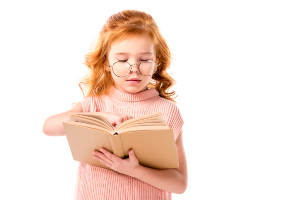 redhead kid in glasses reading book isolated on white - Fotografie, Obrázek