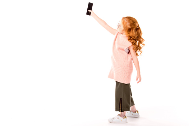 redhead kid taking selfie with smartphone on white - Zdjęcie, obraz
