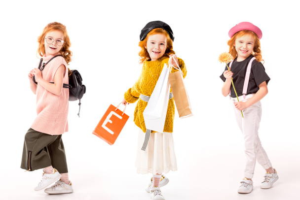 Collage mit demselben Kind in verschiedenen Kleidern und mit verschiedenen Dingen auf Weiß - Foto, Bild