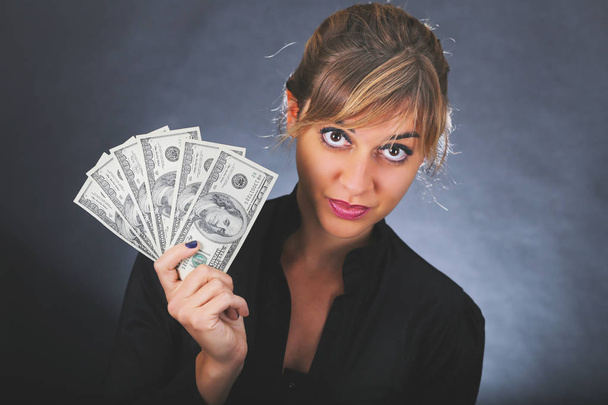 Girl with stack of dollar bills  - Photo, Image