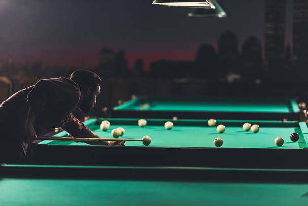 side view of man playing in russian pool at bar  - Photo, Image