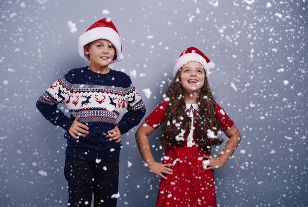 Portrait of siblings among snow falling  - Photo, Image