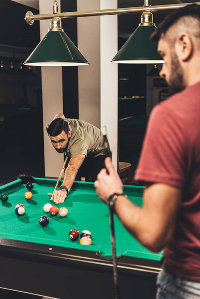 couple of young successful handsome men playing in pool at bar - Foto, Imagem