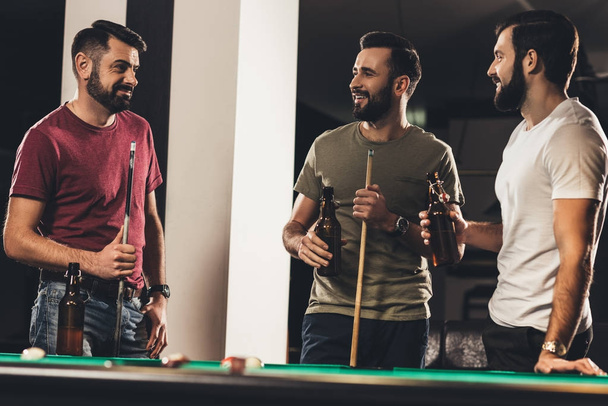 young handsome caucasian men beside billiard table in bar   - Photo, Image