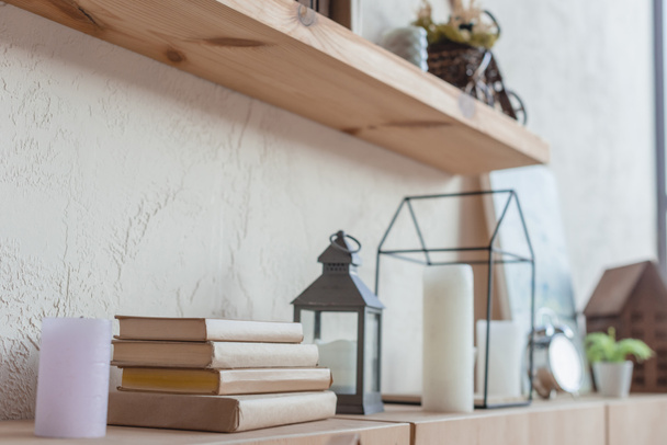 close-up shot of bookshelf with beautiful decorations and stack of books - Φωτογραφία, εικόνα