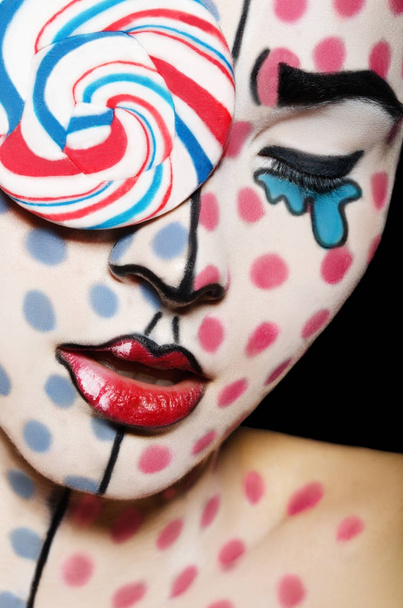 Face art with a lollipop on the face - Fotoğraf, Görsel