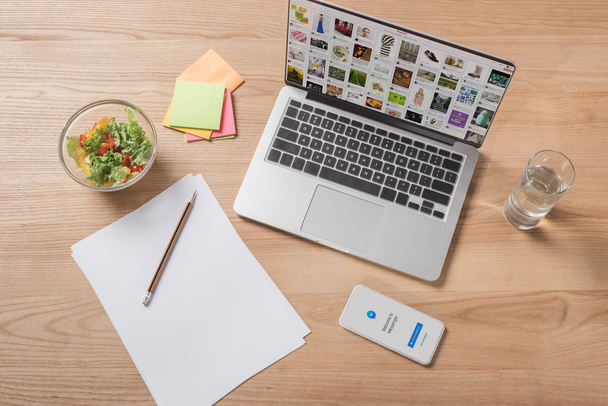 top view of workplace with digital devices and bowl of salad - Fotoğraf, Görsel