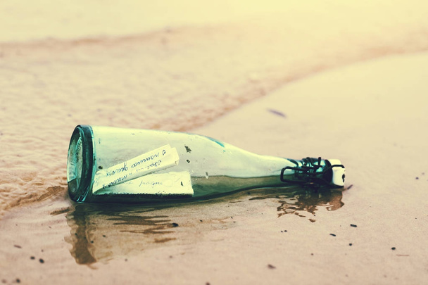 bottle with message on the beach shore sand - Φωτογραφία, εικόνα