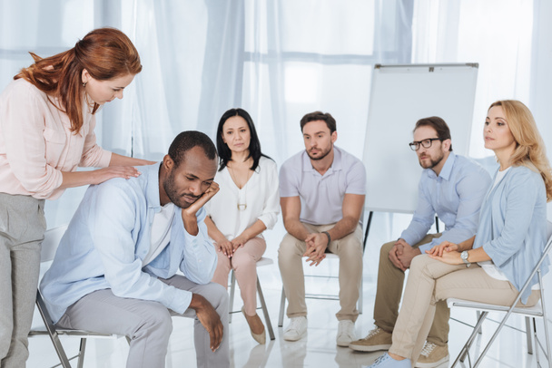psychotherapist supporting african american man during group therapy - Photo, Image