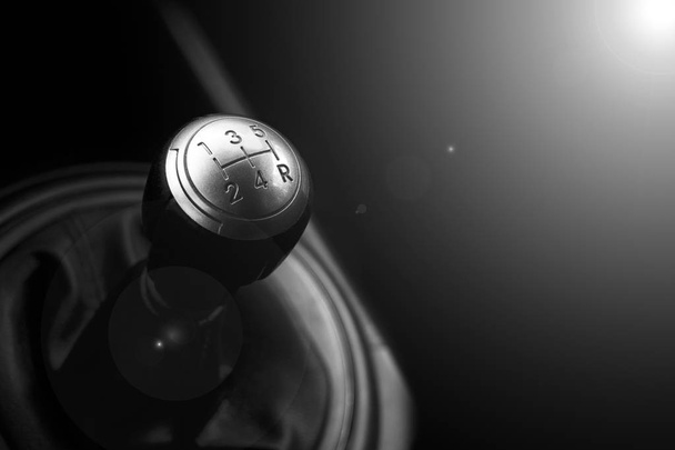 Close up view of a gear lever shift. Manual gearbox. Car interior details. Car transmission. Soft lighting. Abstract view. Black and white - Photo, image
