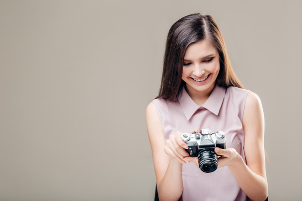 Woman photographer is taking images with dslr camera - Foto, Imagen